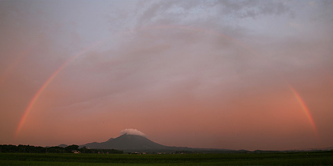 大山にかかる夕暮れの虹